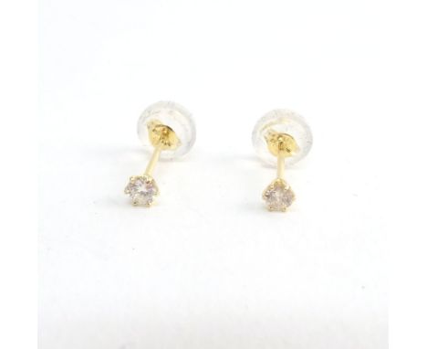 A pair of gold and diamond single stone earstuds, each claw set with a circular cut diamond, detailed K 18 0.05, with a box.