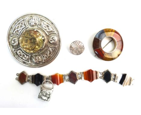 A Scottish silver and citrine set plaid brooch, of circular form, claw set with the circular cut citrine to the centre, withi