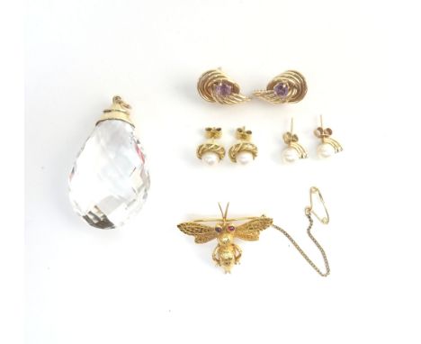 A 9ct gold brooch, designed as a winged insect, having cabochon ruby eyes, London 1973, fitted with a safety chain, a pair of
