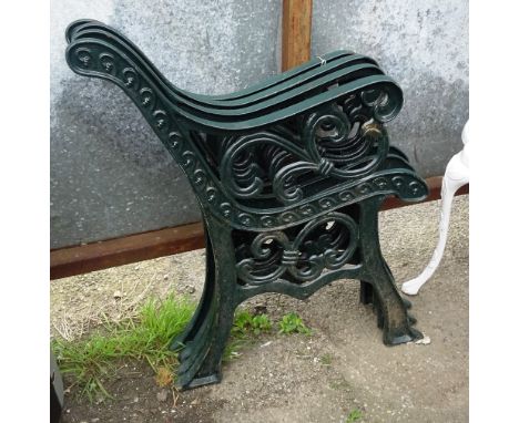 A pair of 20th century green painted bench ends with vine decoration and another pair, (4). 