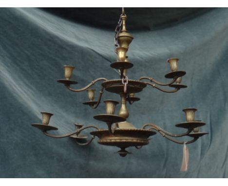 A Victorian style brass twelve branch chandelier, the baluster stem with two knopped roundels issuing twelve branches, over t