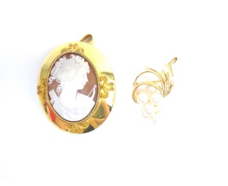 An oval shell cameo pendant brooch, designed as the portrait of a lady, in a ropetwist border, the wide mount with four filig