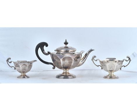 A silver composite three piece tea set, comprising; a teapot, with black composition fittings, a twin handled sugar bowl and 