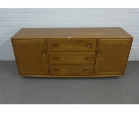 Ercol light elm sideboard with three central drawers flanked by cupboard doors, 145 x 69 x 45cm 