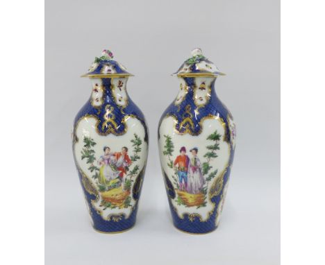 Pair of 19th century porcelain lidded vases painted with figures against a  blue scale ground with gilt highlights and butter