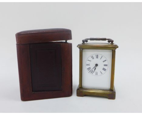 French brass and glass panelled carriage clock, with leather carry case, and key, 15cm high including handle 