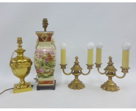 A pair of brass twin light table lamps and another brass table lamp with mask heads and a Japanese style pottery table lamp b