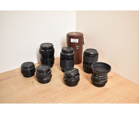 Seven camera lenses. A Pentax M 1:2,8 28mm, a SMC Pentax-A 1:2,8 28mm, a SMC Pentax-A 1:1,7 50mm, a SMC Pentax-A 1:2 50mm, a 