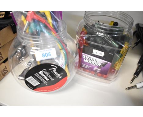 A selection of Fender and Kinsman patch cables and a tub of string winders