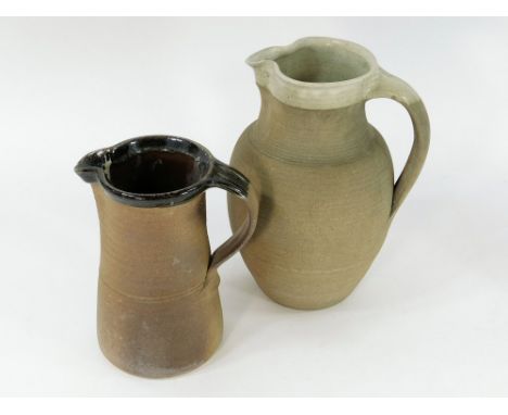 MUCHELNEY ETC. An unmarked quart jug, possibly Winchcombe, height 28cm & a Muchelney Pottery jug, height 20cm, spout chip.  P
