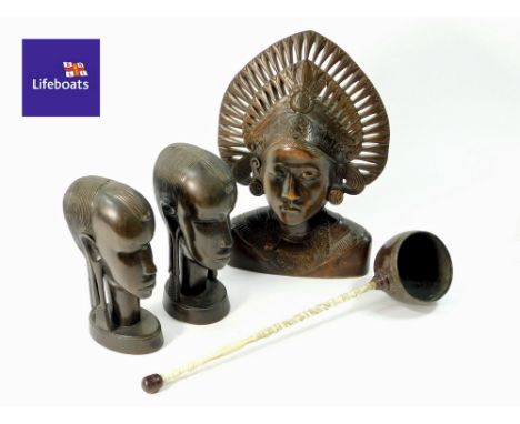 CARVINGS ETC. A carving of the head of a Balinese dancer, a pair of African carved heads & a coconut cup punch ladle.  Please