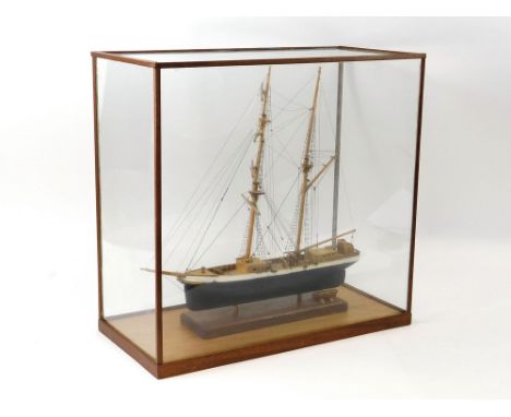 SHIP MODEL. A twin masted ship model in glazed case. Case size: Height 47cm, Width 49cm, Depth 23cm.  Please note that all it
