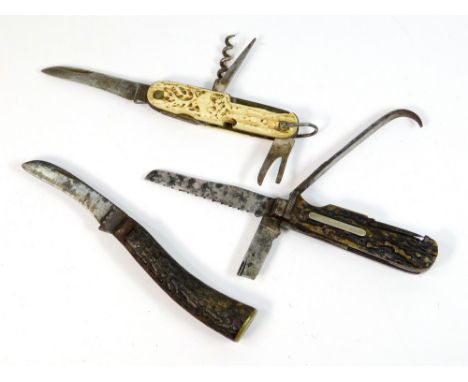 POCKET KNIVES. A German combination pocket knife with carved bone handle. Also, two pocket knives with antler handles includi