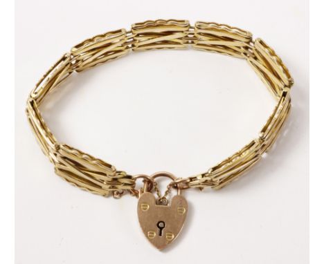 Gold crossed bar gate bracelet the heart padlock stamped 9ct approx 19gm   Condition Report   Click here for further images, 