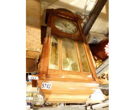 Vintage leather suitcase and a wooden cased wall clock