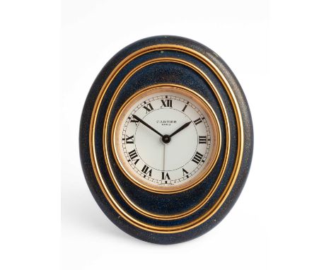 A Cartier oval bedside alarm clock, the circular dial with Roman numerals, numbered 7511 00008, 10cm x 8.5cmA couple of small