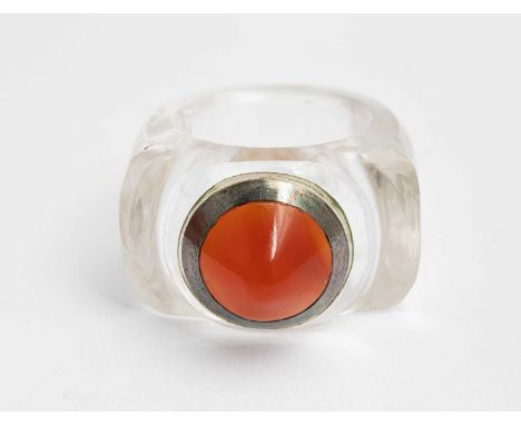 An Art Deco rock crystal, carnelian and white metal ring of domed target form, approximately 18.7gTwo small fractures within 