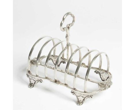 A Victorian silver toast rack Henry Wilkinson &amp; Co., Sheffield 1854, with trefoil shaped loop handle and seven arched div