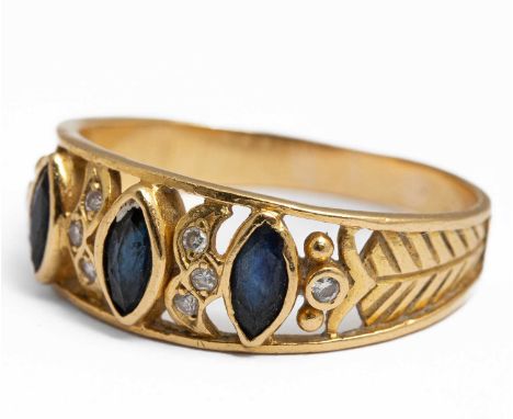 A yellow gold sapphire and diamond ring, set with three marquise cut sapphires and eight small round brilliant cut diamonds, 