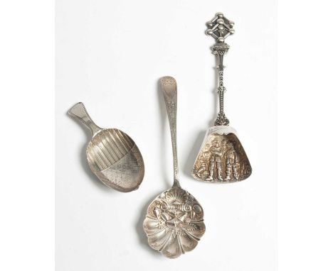 A George III silver caddy spoon of acorn form, IT, Birmingham 1800, another silver spoon and a Continental white metal caddy 
