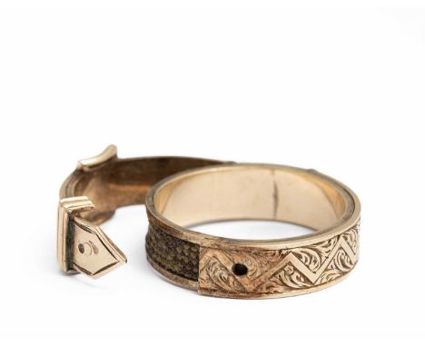 A 19th Century yellow gold and hairwork memorial buckle ring, the outer band chased and engraved with foliate detail, opening