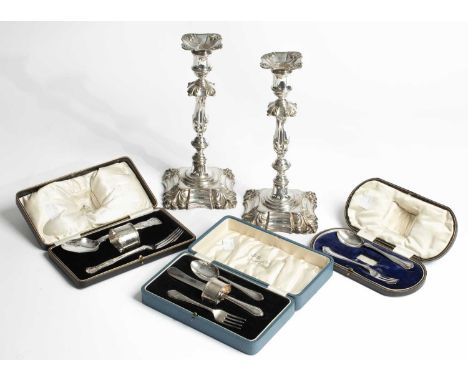 Three silver cased cutlery sets, 289g and a pair of silver plated candlesticks 29cm high (4)