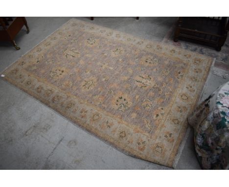 A traditional rug, light colours and quite faded, approx 180 x 120cm