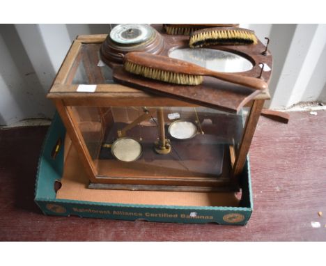 A traditional glass cased lab scale and a wall mirror/barometer
