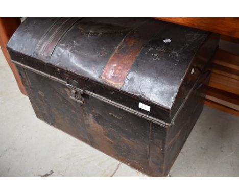 A traditional tin trunk having dome top