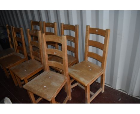 A set of eight traditional heavy wood frame ladder back kitchen dining chairs