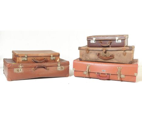 A collection of five vintage mid 20th century tan leather travel suitcases of various sizes.&nbsp;
