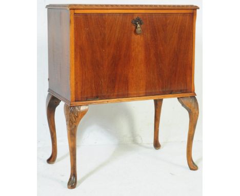 A vintage 20th century mahogany Queen Anne Revival record cabinet. Of square form with twin front doors with metal circular p