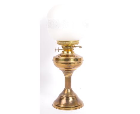 An early 20th century brass oil lamp. Having a glass flute shade and a acid etched bulbous shade. With brass reeded column an
