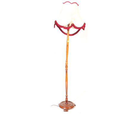 A retro vintage mid 20th century teak wood standard standing floor lamp light. With fixing to top, turned wood decoration to 