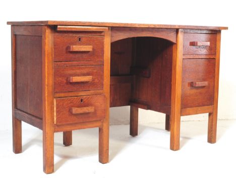 A vintage, retro, mid 20th century double pedestal oak air ministry writing desk. The desk having two double sided banks of d