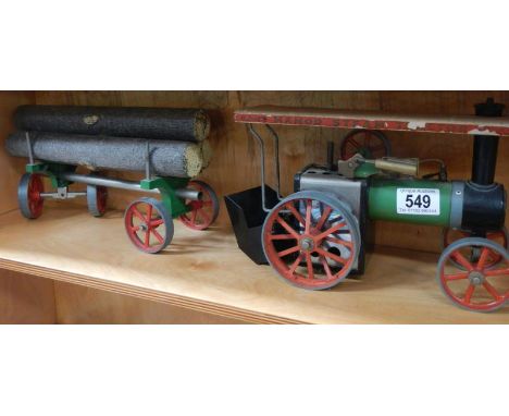 A Mamod TE1 steam engine with log trailer