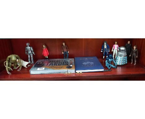 An assortment of Doctor Who figures plus Secrets of the Tardis &amp; Tardis type 40 instruction manual