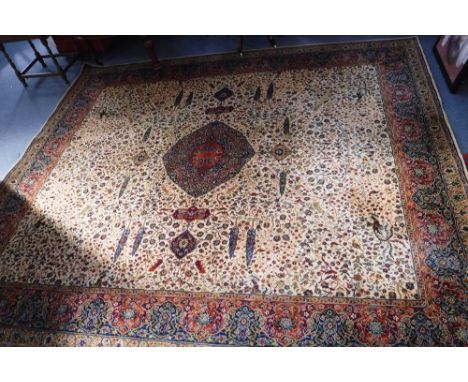 A CREAM GROUND WILTON CARPET with a Persian design 144" long x 126" wide