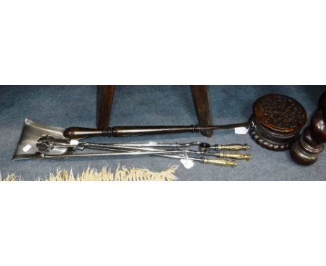 A SET OF THREE HIGHLY POLISHED 19TH CENTURY IRON FIRE TOOLS with brass handles and a wooden handles brass chestnut roaster 