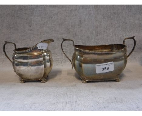 A CHESTER SILVER PANELLED TWO HANDLED SUCRIER AND CREAM JUG with engraved initials 'EEA' (2)