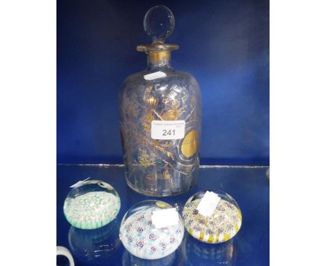 A CONTINENTAL GLASS AND GILT DECORATED DECANTER AND STOPPER and three small paperweights