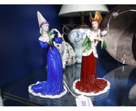 TWO CERAMIC FIGURES OF WOMEN IN MEDIEVAL COSTUME holding birds