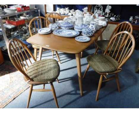 ERCOLL: A PALE ELM AND BEECH DINING TABLE, 32" wide x 57" long (plus extra folding leaf) and six stick back chairs