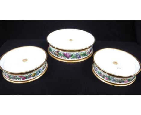 A THREE TIER CERAMIC CAKE STAND with gilt and floral decoration