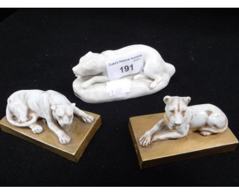 THREE CERAMIC ORNAMENTS of recumbent animals, two on gilt bases