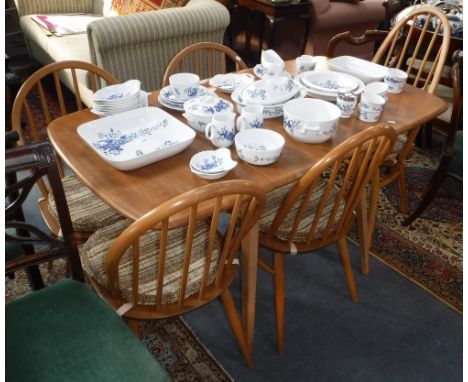 ERCOLL: A PALE ELM AND BEECH DINING TABLE, 53" long (inc leaf) x 29" wide with four matching stick-back chairs and one carver