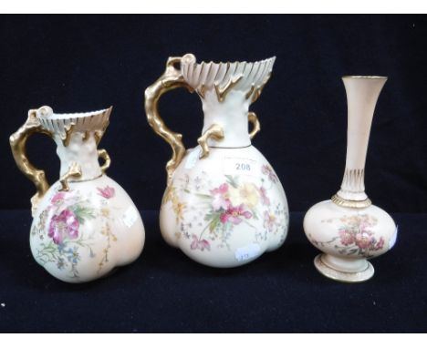 A GRADUATED PAIR OF ROYAL WORCESTER BLUSH IVORY JUGS and a similar vase