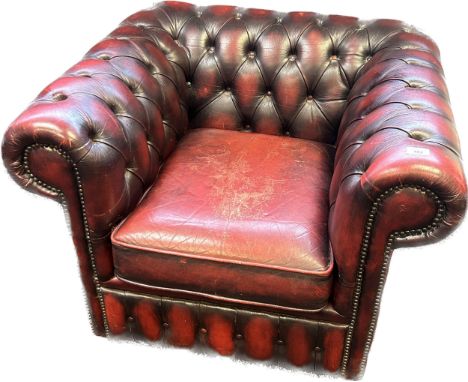 Chesterfield club chair, covered in a red leather button upholstery 