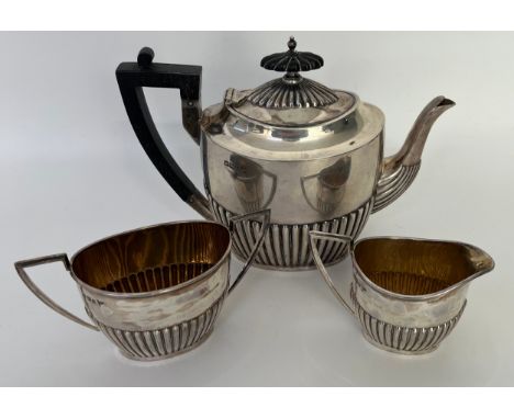 Three piece Sheffield silver tea service; tea pot, cream jug and sugar bowl. Produced by Walker &amp; Hall. [733grams] 