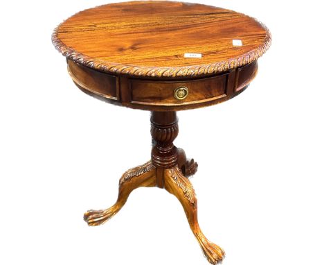 Reproduction mahogany drum table, the circular top with pie crust edging, raised on a tripod base ending in out swept legs an